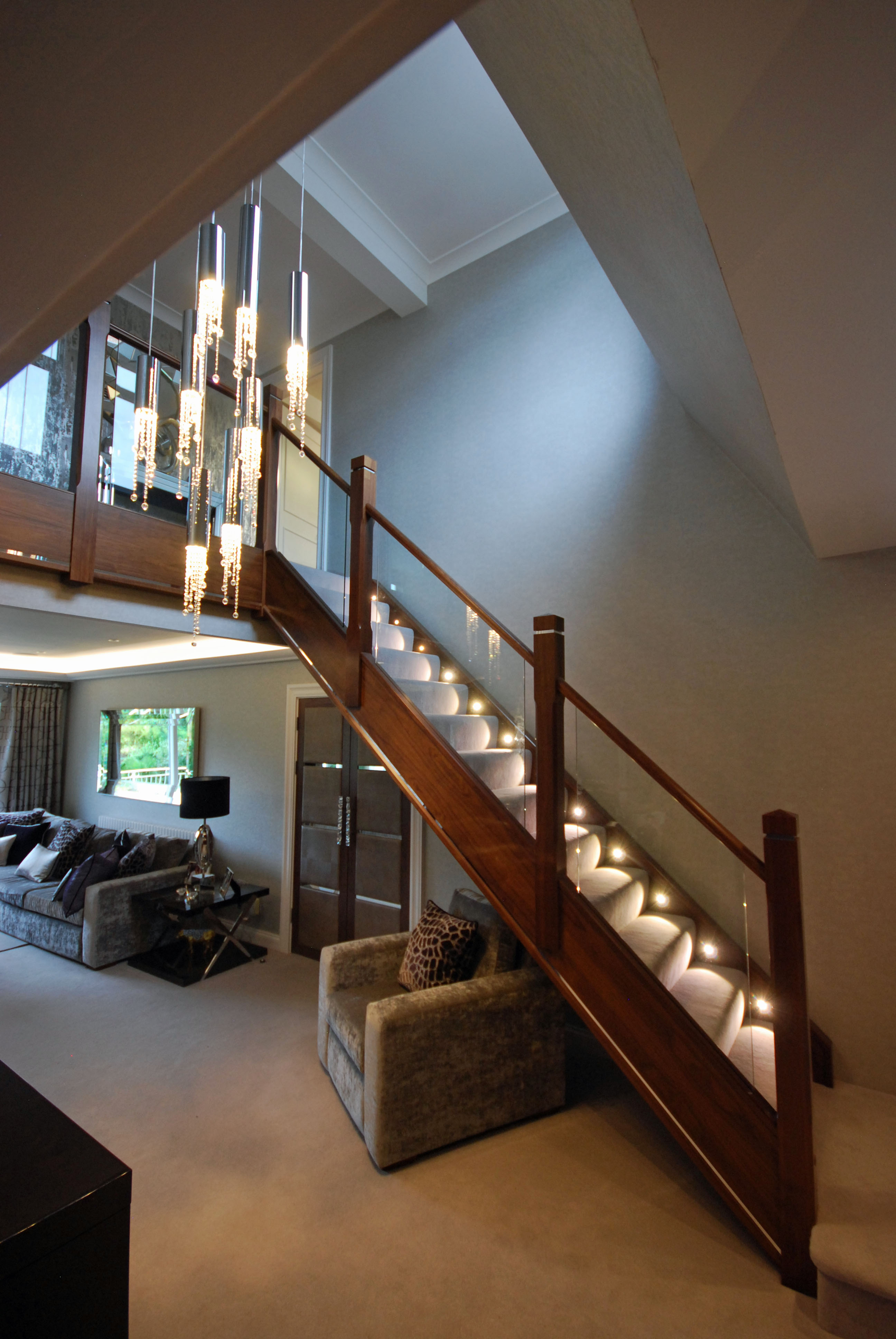 Walnut Staircase with inset lighting and mirror inlay