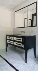 black vanity unit with four mirror drawers. black leather handles.